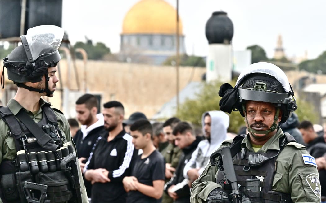 Israeli security forces stand guard as Palestinian Muslims gather for Friday prayer in east Jerusalem on 29 December, 2023, amid ongoing battles between Israel and the militant Hamas group in Gaza.