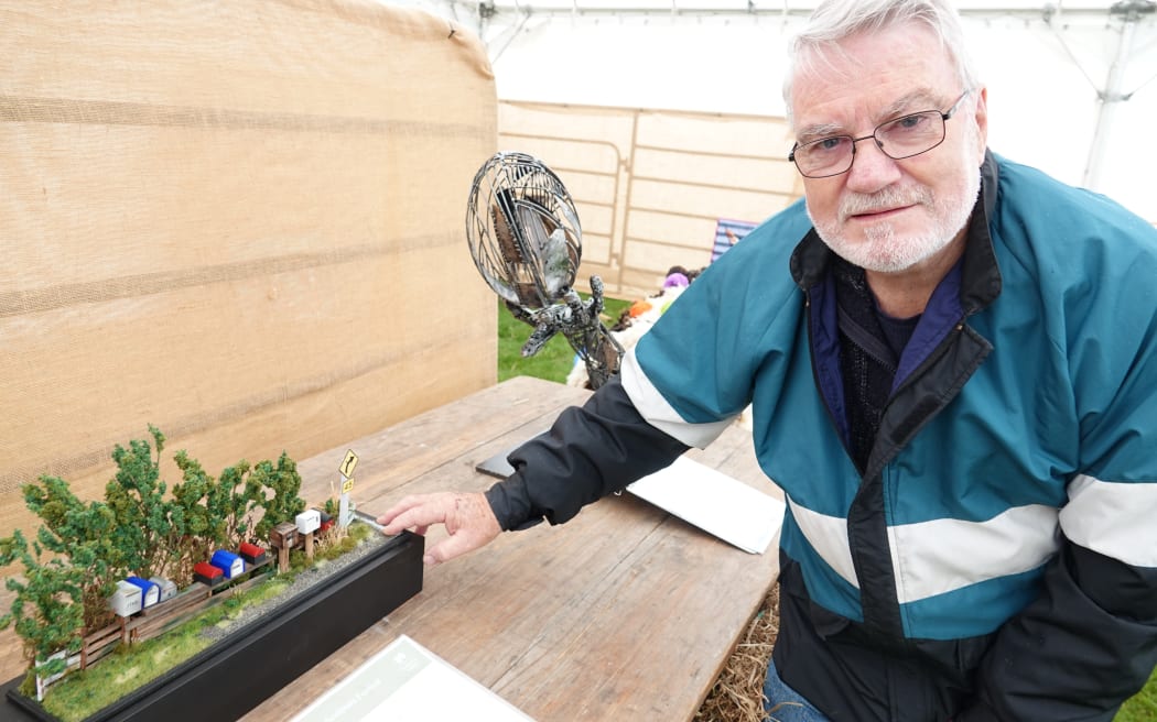 Jim Lowe, with one of his smaller creations - a collection of northern Manawatū letterboxes.