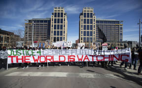 People march during a demonstration in honour of George Floyd on 8 March 2021 in Minneapolis, Minnesota, the day the jury selection began in the trial of former Minneapolis Police officer Derek Chauvin in the death of George Floyd last May.