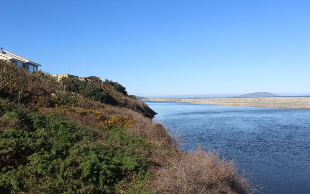 Houses in the area overlook the Waiau River, and on the other side of that, the ocean.