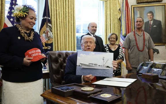 WASHINGTON, DC - APRIL 17: U.S. Delegate Amata Coleman Radewagen (L) of American Samoa joins President Donald Trump as he signs a proclamation in the Oval Office at the White House on April 17, 2025 in Washington, DC. The proclamation expands fishing rights in the Pacific Islands to an area he described as three times the size of California.   Win McNamee/Getty Images/AFP (Photo by WIN MCNAMEE / GETTY IMAGES NORTH AMERICA / Getty Images via AFP)