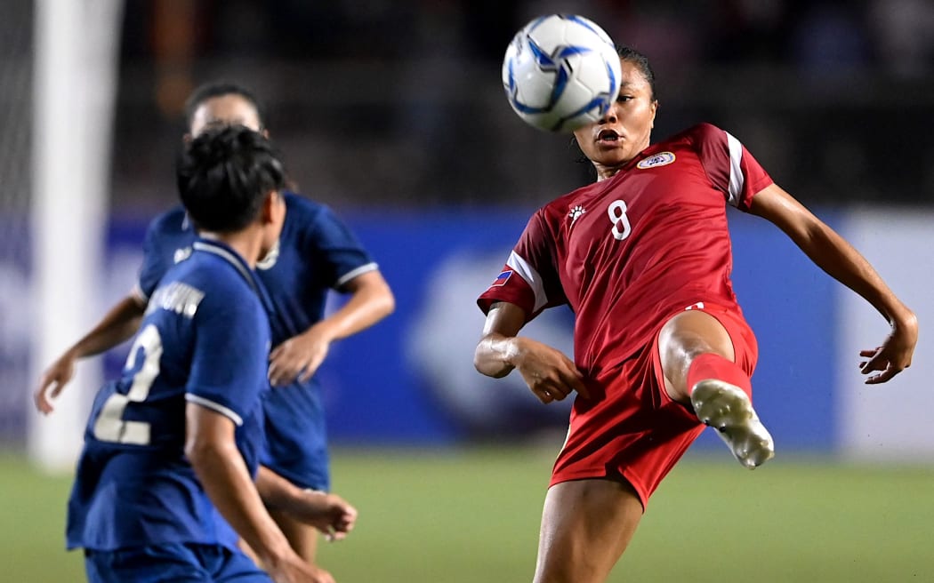 Sarina Isabel Calpo Bolden (R) of the Philippines challenges for the ball of Thailand during the Women’s Asian Football Federation semi-final match at the Rizal Memorial Coliseum in Manila on July 17, 2022. (Photo by JAM STA ROSA / AFP)