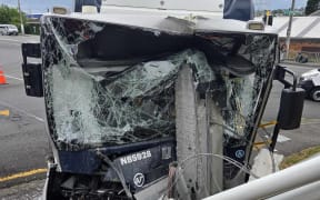 A bus has collided with a power pole in New Lynn, causing damage to Green Bay Auctions.