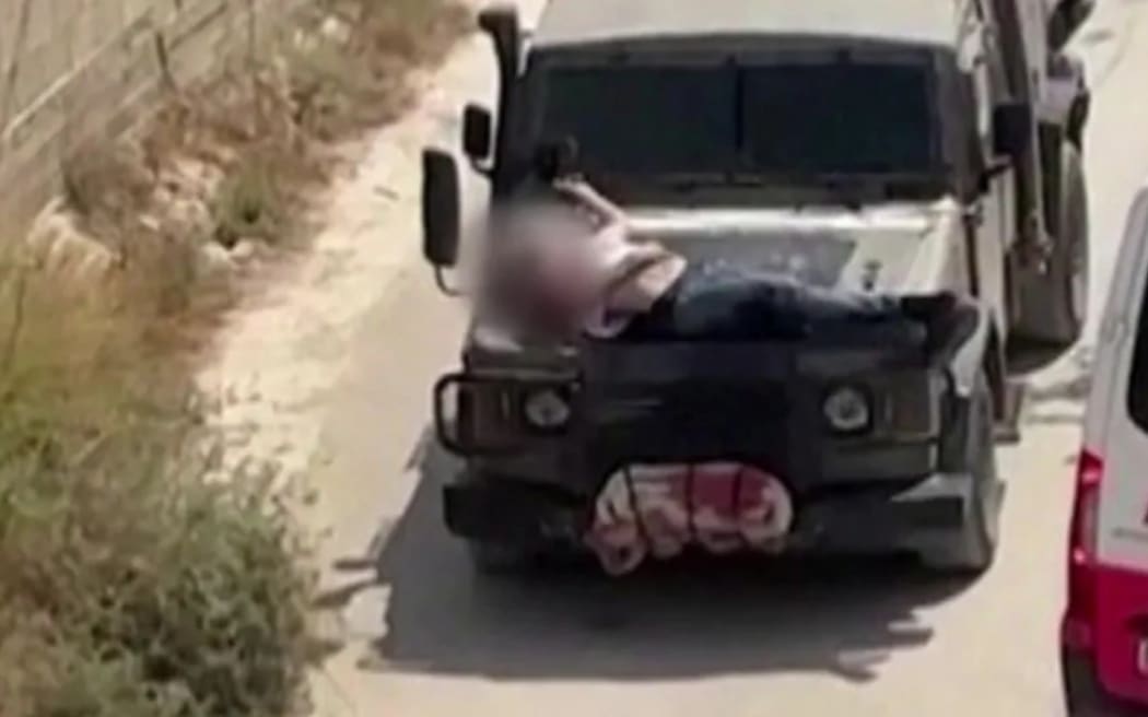 A man strapped to the front of an IDF vehicle