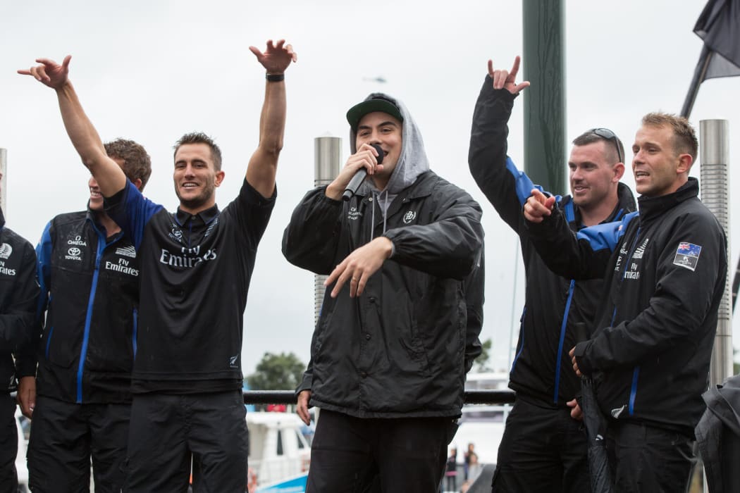 David Dallas performs with members of Team New Zealand.
