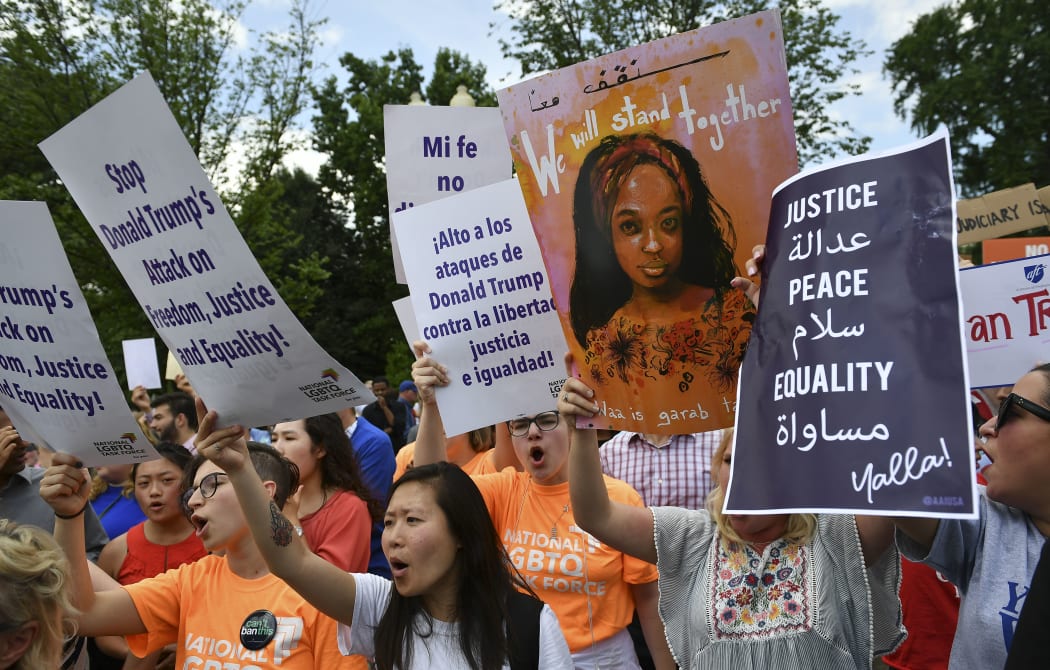 People protesting against the Muslim travel ban outside the US Supreme Court in Washington, DC, 26 June 2018.