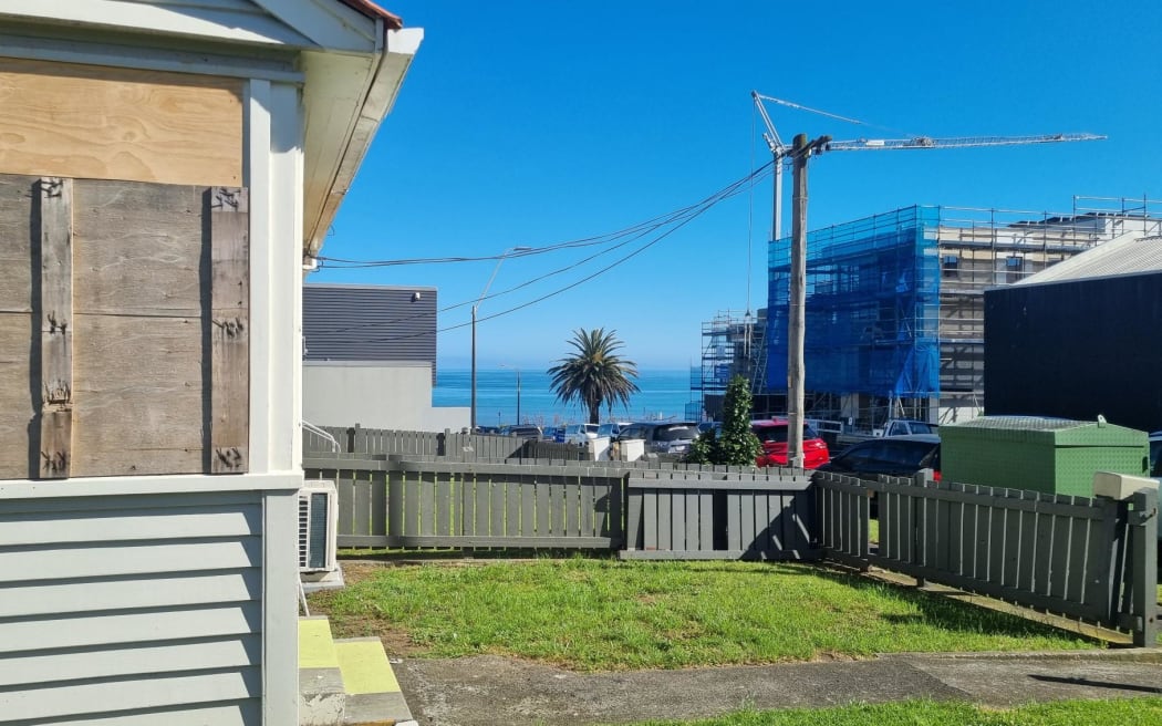 The boarded up flats on Dawson Street enjoy seasviews and are neighboured by modern townhouses. Former mayor Peter Tennent is developing two buildings across the road including one which will house a family apartment overlooking the Tasman Sea.