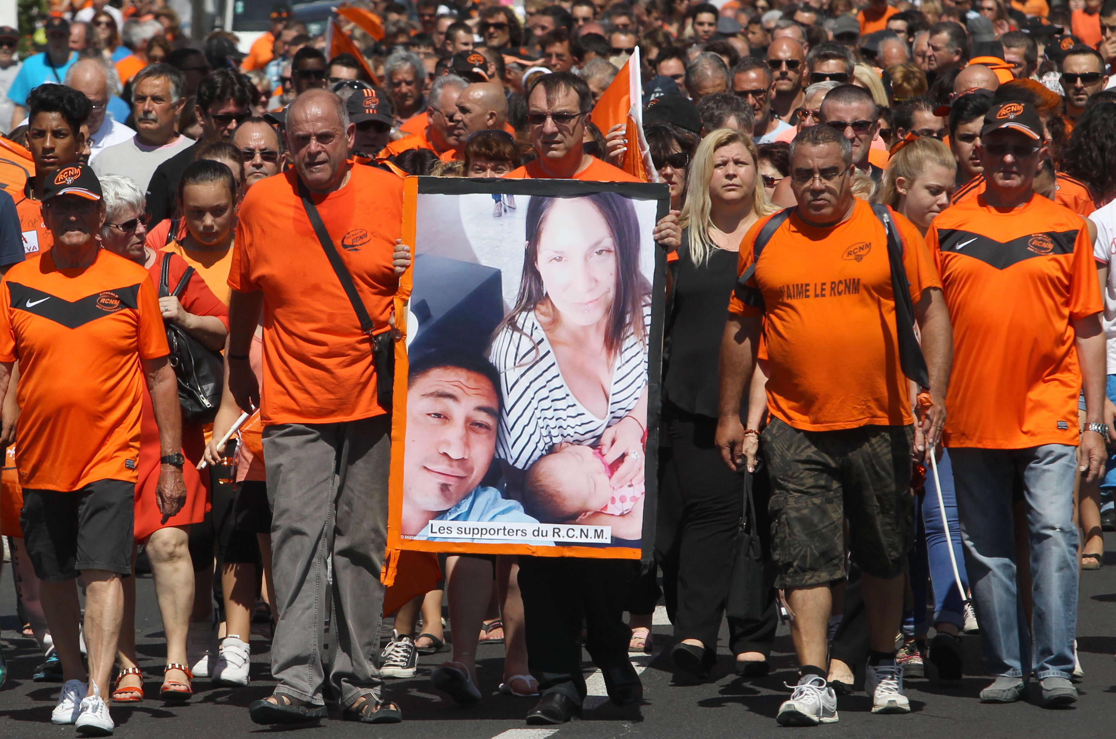 French RCN (racing club de Narbonne) supporters hold a picture of All Black's Jerry Collins and his partner.
