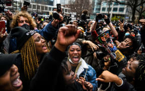 People celebrate as the verdict is announced in the trial of former police officer Derek Chauvin outside the Hennepin County Government Center in Minneapolis, Minnesota on April 20, 2021.