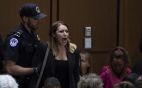 A demonstrator shouts as Judge Brett Kavanaugh arrives prior to a hearing before the United States Senate Judiciary Committee on his nomination as Associate Justice of the US Supreme Court.