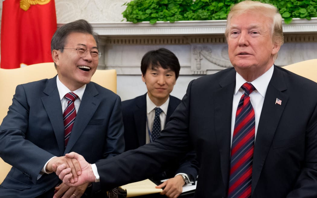 US President Donald Trump and South Korean President Moon Jae-in shake hands during a meeting in the Oval Office of the White House.