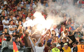 Football fans ignite flares during the UEFA Euro 2016 group stage match between the English and Russian national teams.