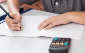 School child with calculator