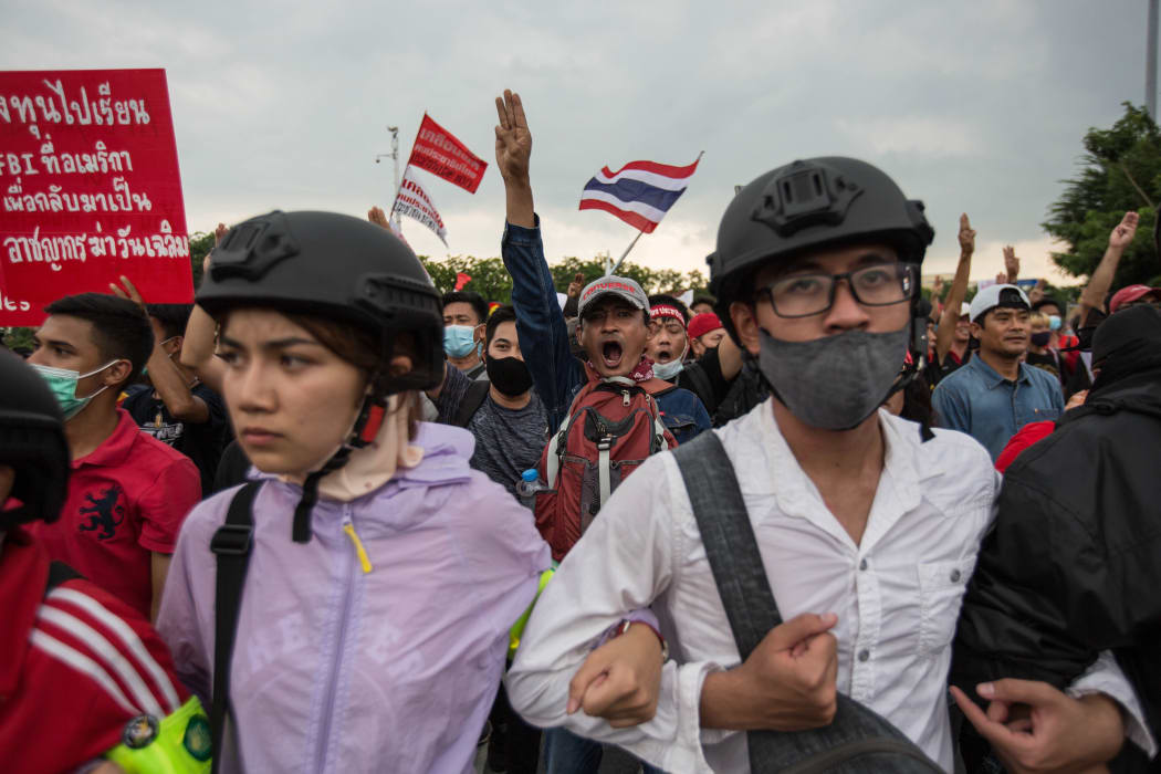 Pro-democracy protesters march toward  Government House during an anti government demonstration on October 14, 2020 in Bangkok, Thailand.