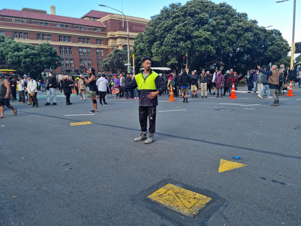 Protesters directing traffic so cars can get through.