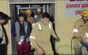 Emergency personnel work at the scene of a fire that killed 10 newborns in Jhansi city, India, on November 15, 2024.