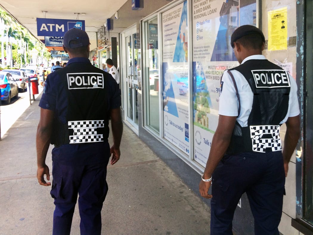 Fijian police officers patrolling in the main street in Lautoka