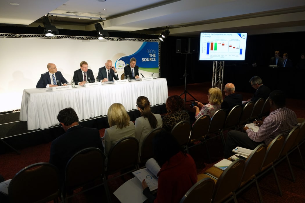 Fonterra managers announce a large profit fall to media in Auckland.