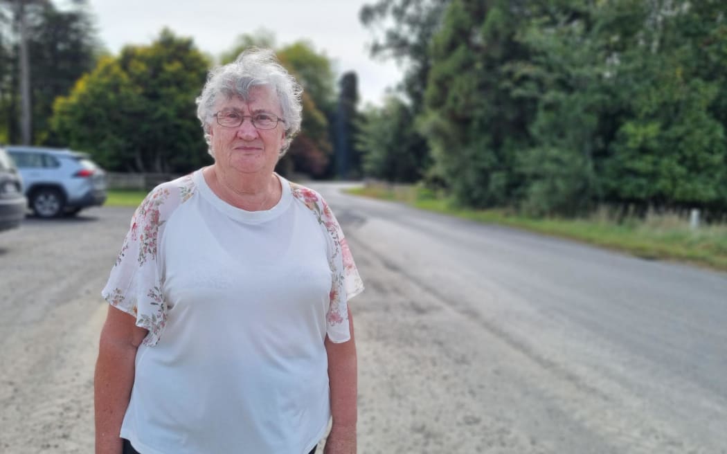 Tarata Women's Institute member June Pawley stands on Tarata Rd, Taranaki.