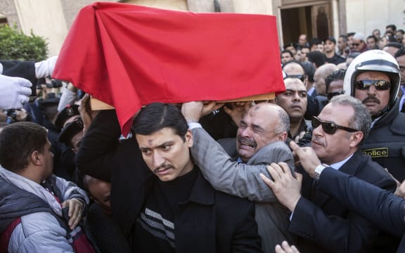 Mourners carry the coffin of General Mohamed Saeed in Cairo.