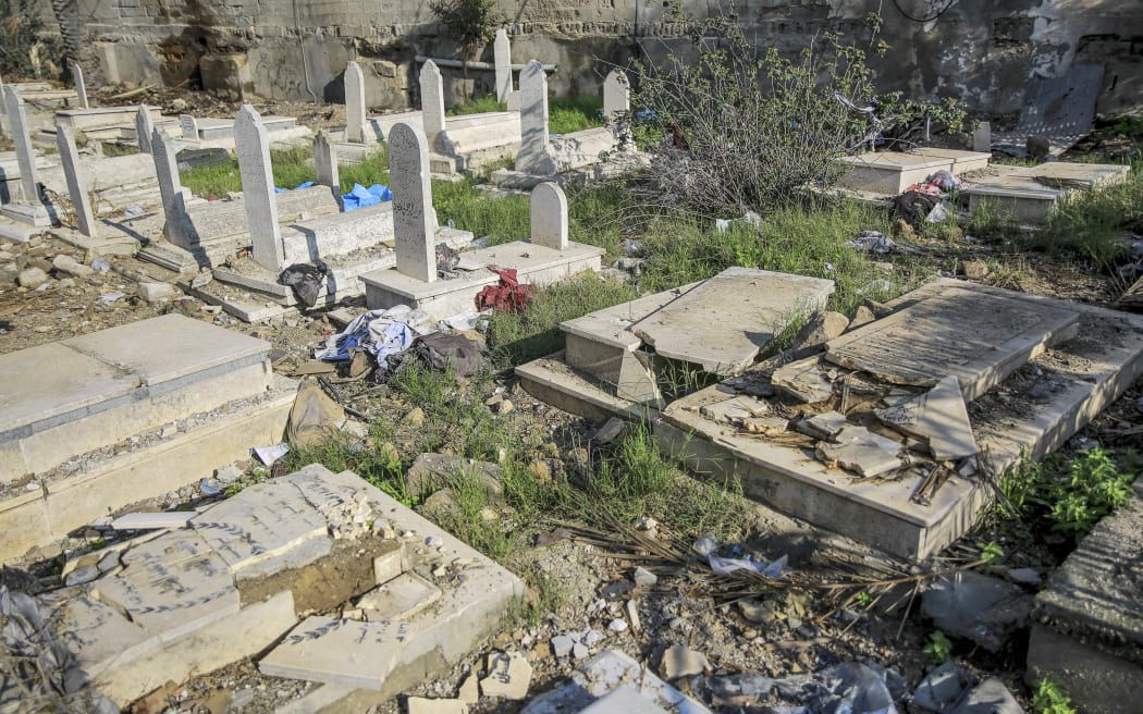 A picture taken on January 5, 2024 shows Gaza City's Al-Ghossein cemetery, damaged amid the ongoing conflict between Israel and the militant group Hamas. The conflict triggered by Hamas's deadly October 7 attack on Israel has caused massive destruction in the Gaza Strip, killing tens of thousands and leaving residents on the brink of famine. Much of the territory has become unrecognisable, as entire neighbourhoods which were once bustling with people, cars and donkey-drawn carts have been reduced to rubble. (Photo by AFP)