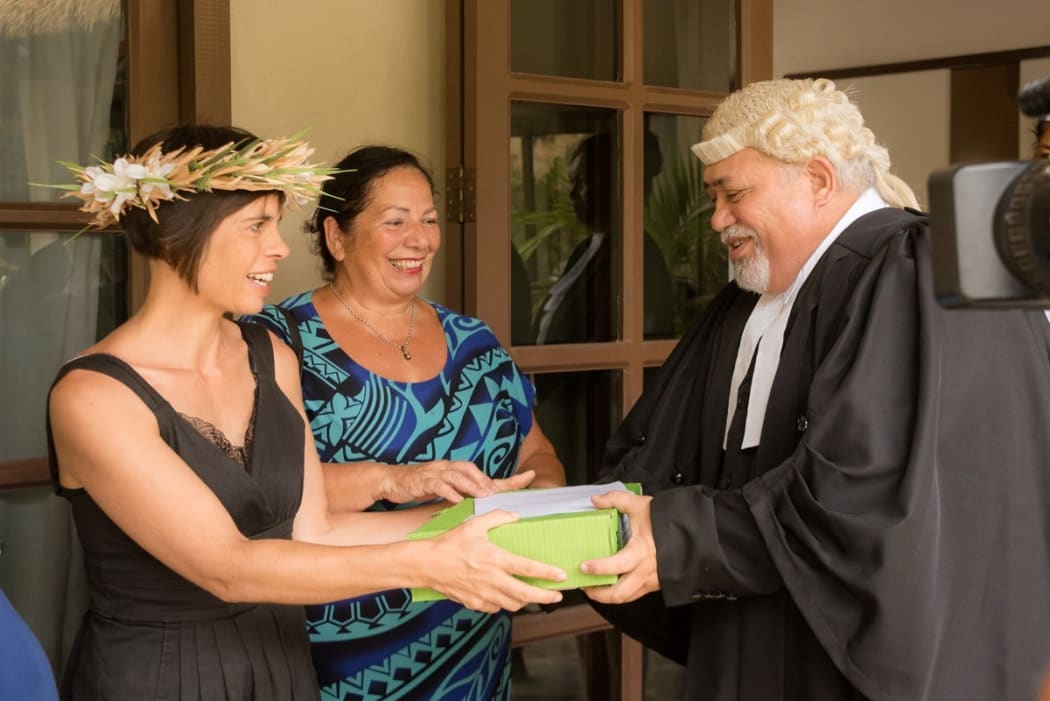 Te Vai Ora Maori members Justine Flanagan and Imogen Ingram hand Clerk of Parliament Tangata Vainerere the petition opposing the proposed chemical treatment of the Rarotonga water system.