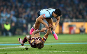 Joseph-Aukuso Sua'ali'i tackles Reece Walsh during Game 1 of the State of Origin 2024 .