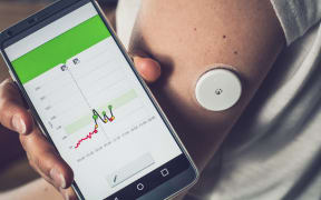 A continuous glucose monitor lets users test their blood sugar with a scanner or phone.
