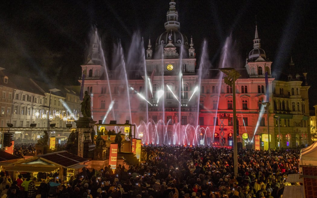 Hundreds of tourists and citizens attend a water and laser show to celebrate the New Year 2023 on the main square in Graz, Austria, on December 31, 2022.