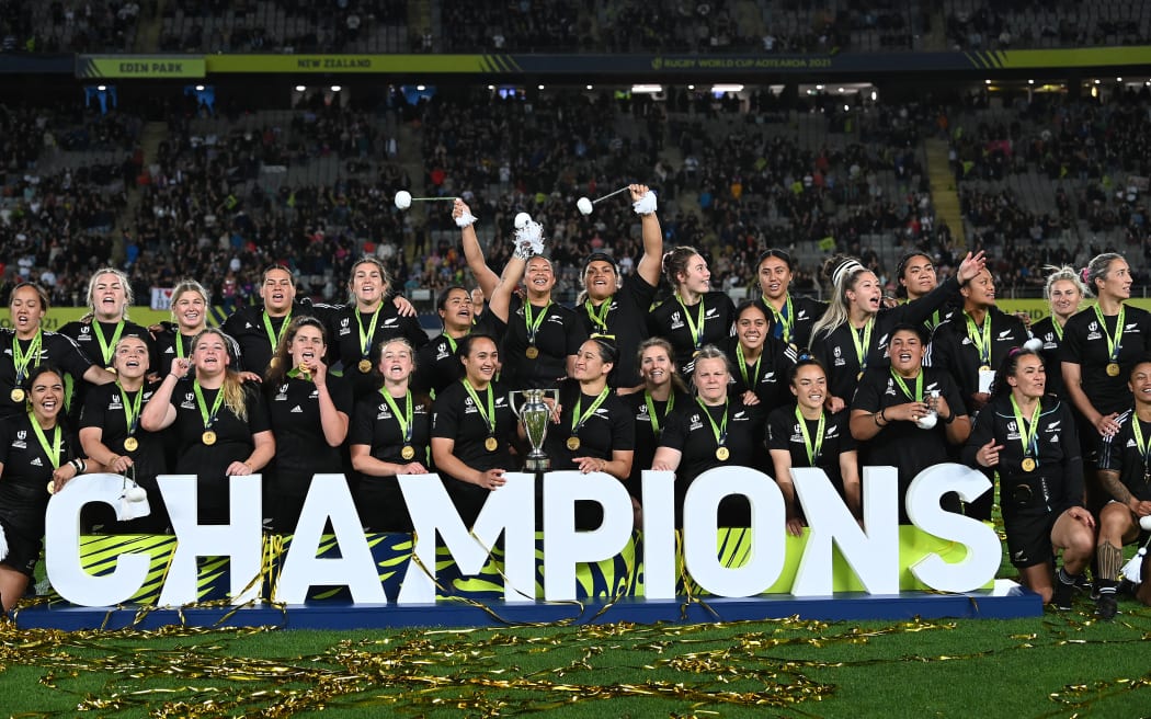 New Zealand celebrate with the Rugby World Cup trophy after winning the final.