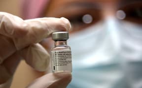 A nurse holds a vial of the Pfizer vaccine at the Pablo Arturo Suarez Hospital in Quito on January 21, 2021.