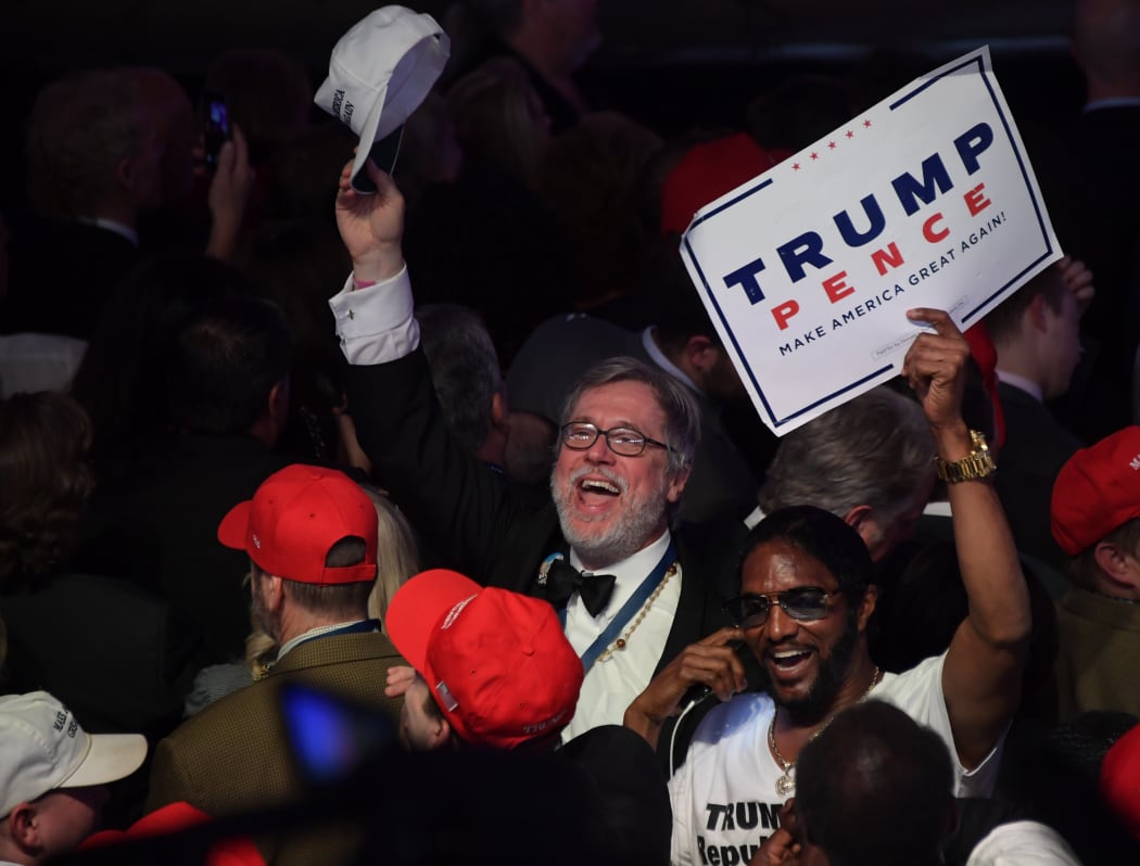 Supporters of Republican presidential nominee Donald Trump celebrates during election night at the New York Hilton Midtown in New York on November 9, 2016.