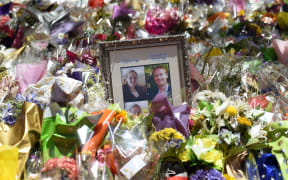 Photos showing Katrina Dawson (L) and Tori Johnson (R) sit amongst the floral tributes left outside the Lindt cafe in Sydney's Martin Place, one week after the siege.