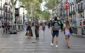 People walk on Las Ramblas  a day after a van ploughed into the crowd.