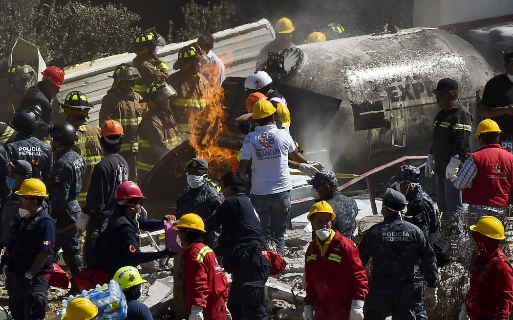 Rescuers work amid the wreckage caused by an explosion in a hospital in Cuajimalpa, Mexico City.