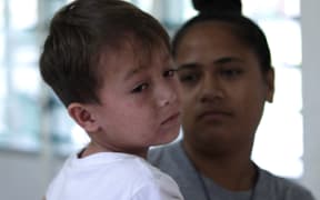 A mum and her son turn up to Poutasi District Hospital's measles ward. There are four infected children here.
