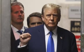 Former US President Donald Trump gestures as he returns from a recess in his trial for allegedly covering up hush money payments linked to extramarital affairs, at Manhattan Criminal Court in New York City on April 18, 2024. Trump's criminal trial resumes Thursday with Judge Juan Merchan seeking to complete jury selection. Moving the US into uncharted waters, it is the first criminal trial of a former US president, one who is also battling to retake the White House in November. (Photo by Brendan McDermid / POOL / AFP)