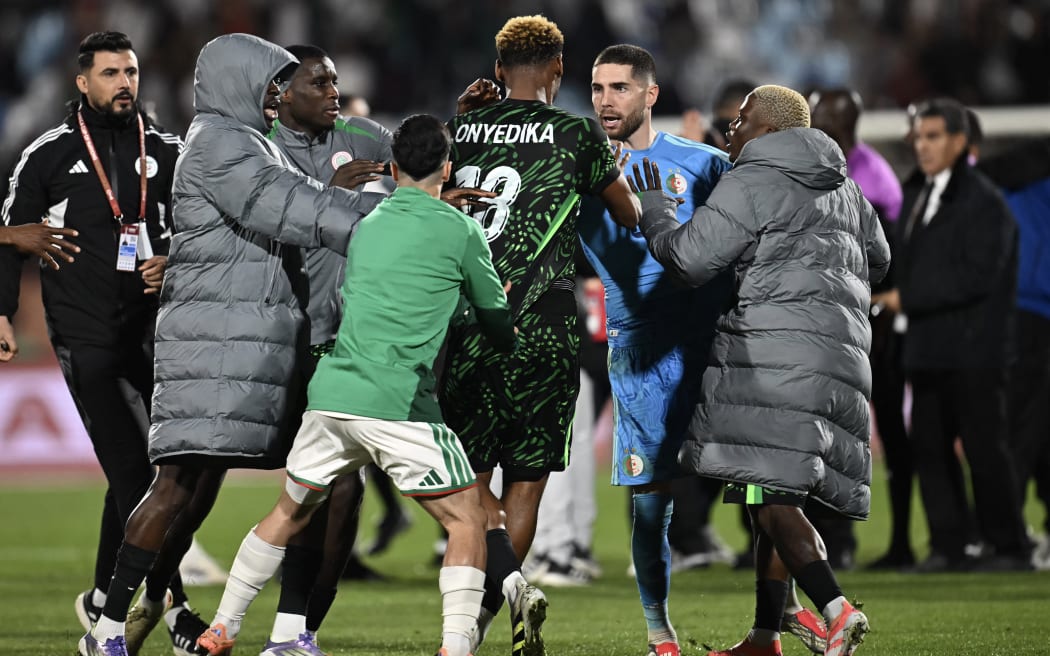 Nigeria's midfielder #18 Raphael Onyedika, Algeria's goalkeeper #23 Luca Zidane and players argue during the Africa Cup of Nations (CAN) quarter-final football match between Algeria and Nigeria at the Grand stadium in Marrakesh on January 10, 2026. (Photo by Paul ELLIS / AFP)