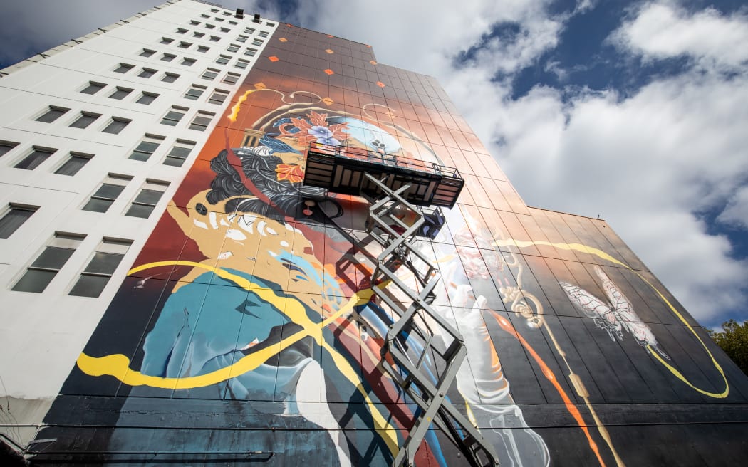 Artist Jacob Yikes (Jacob Ryan) working on New Zealand's largest mural outside the Distinction Christchurch Hotel.