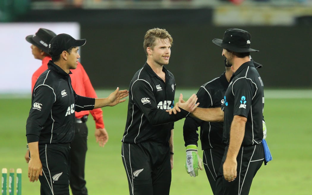 Lockie Ferguson congratulated by team-mates.