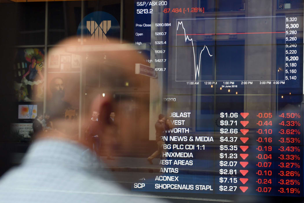 man monitors trading at a stock exchange in Sydney on June 24, 2016.