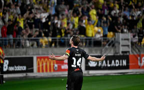 Alex Rufer (C) of the Phoenix celebrates after scoring a goal during the A-League.