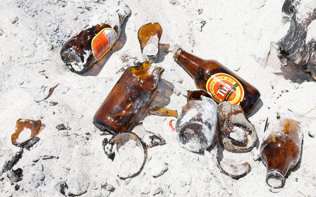 Mount Locals are having to pick up broken glass and rubbish on the beach from parties.