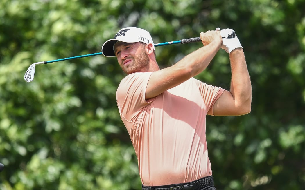 Wyndham Clark hits a tee shot during a practice round