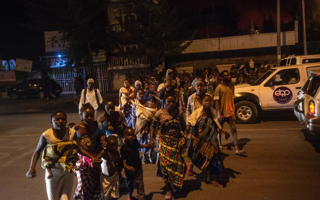 Goma residents are seen leaving the city following a sudden activity of the Nyiragongo volcano on 22 May 2021.