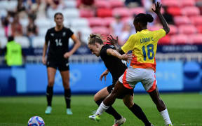 New Zealand's defender #04 CJ Bott (L)  fights for the ball with Colombia's midfielder #08 Marcela Restrepo  during the women's group A football match between New Zealand and Colombia of the Paris 2024 Olympic Games at the Lyon Stadium in Lyon on July 28, 2024. (Photo by Olivier CHASSIGNOLE / AFP)