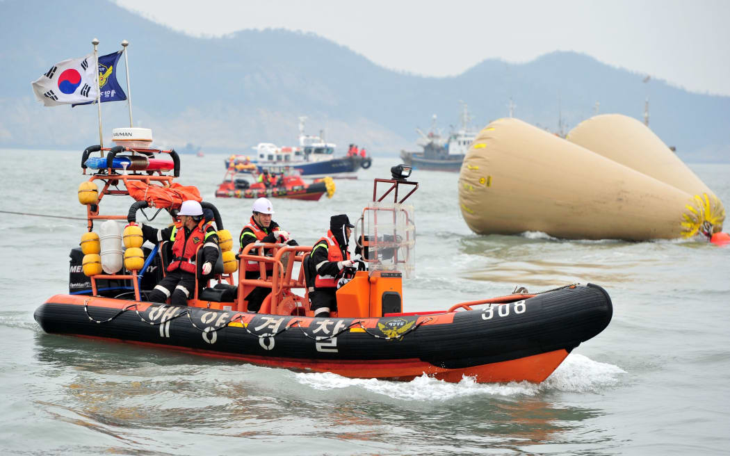 South Korean rescue members search for missing passengers on the capsized ferry.