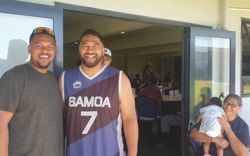 Taylor Chricton (left) with church volunteer Fuimaono Pulega.