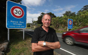 Parua Bay village's 30km/h speed zone needs additional speed bridges to property slow vehicles still travelling too quickly past local Pārua Bay School (back left distance) says resident Colin Edwards.