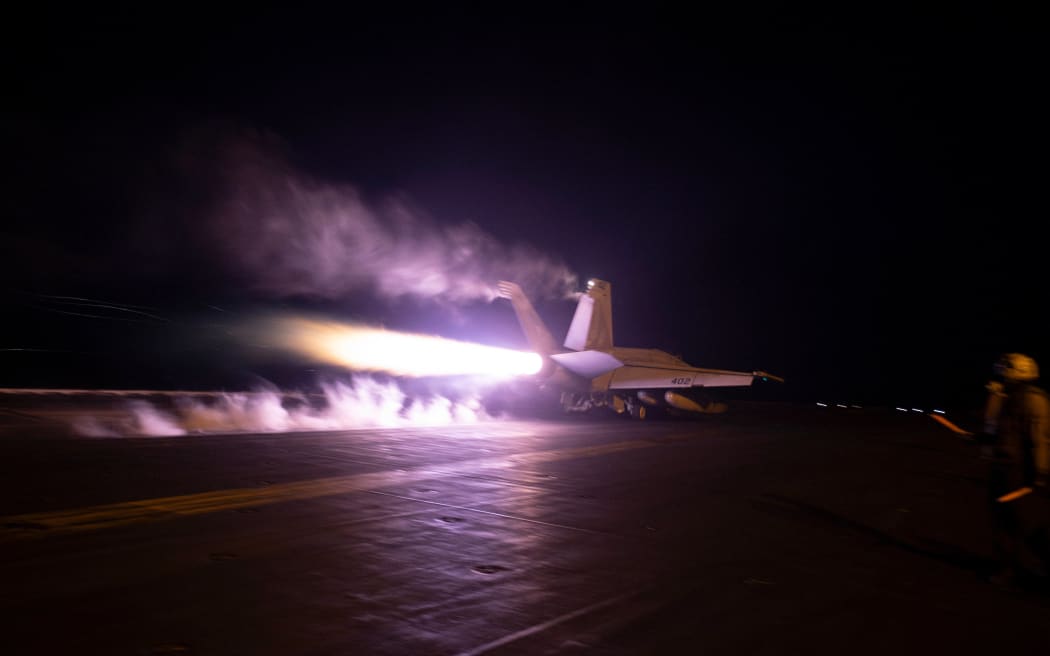 In this photo released by the US military's Central Command on January 22, 2024, US Central Command forces alongside UK Armed Forces, and with the support from Australia, Bahrain, Canada, and the Netherlands, conduct strikes on 8 Houthi targets in Iranian-backed Houthi terrorist-controlled areas of Yemen. The United States and Britain launched new strikes on Yemen's Huthis January 22, saying their second round of joint military action against the Iran-backed rebels was in response to continued attacks on shipping.American and British forces carried out a first wave of strikes against the rebel group on January 11, and the United States launched further air raids against missiles that Washington said were ready to launch and posed a threat to both civilian and military vessels. (Photo by Handout / US Central Command (CENTCOM) / AFP) / RESTRICTED TO EDITORIAL USE - MANDATORY CREDIT "AFP PHOTO /  HANDOUT / CENTCOM " - NO MARKETING - NO ADVERTISING CAMPAIGNS - DISTRIBUTED AS A SERVICE TO CLIENTS